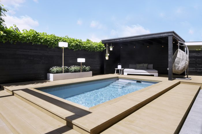 Overzichtsfoto van een bouwkundig zwembad met lounge en overkapping